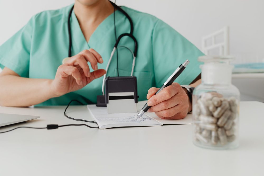 A pharmacist preparing a compounded medication at a lab bench