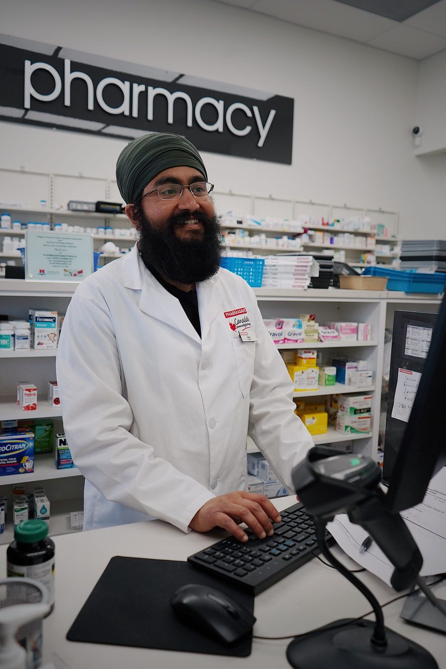 A community pharmacist at the counter of a modern pharmacy