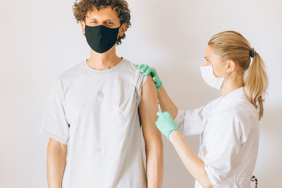 A pharmacist administering a vaccine to a patient