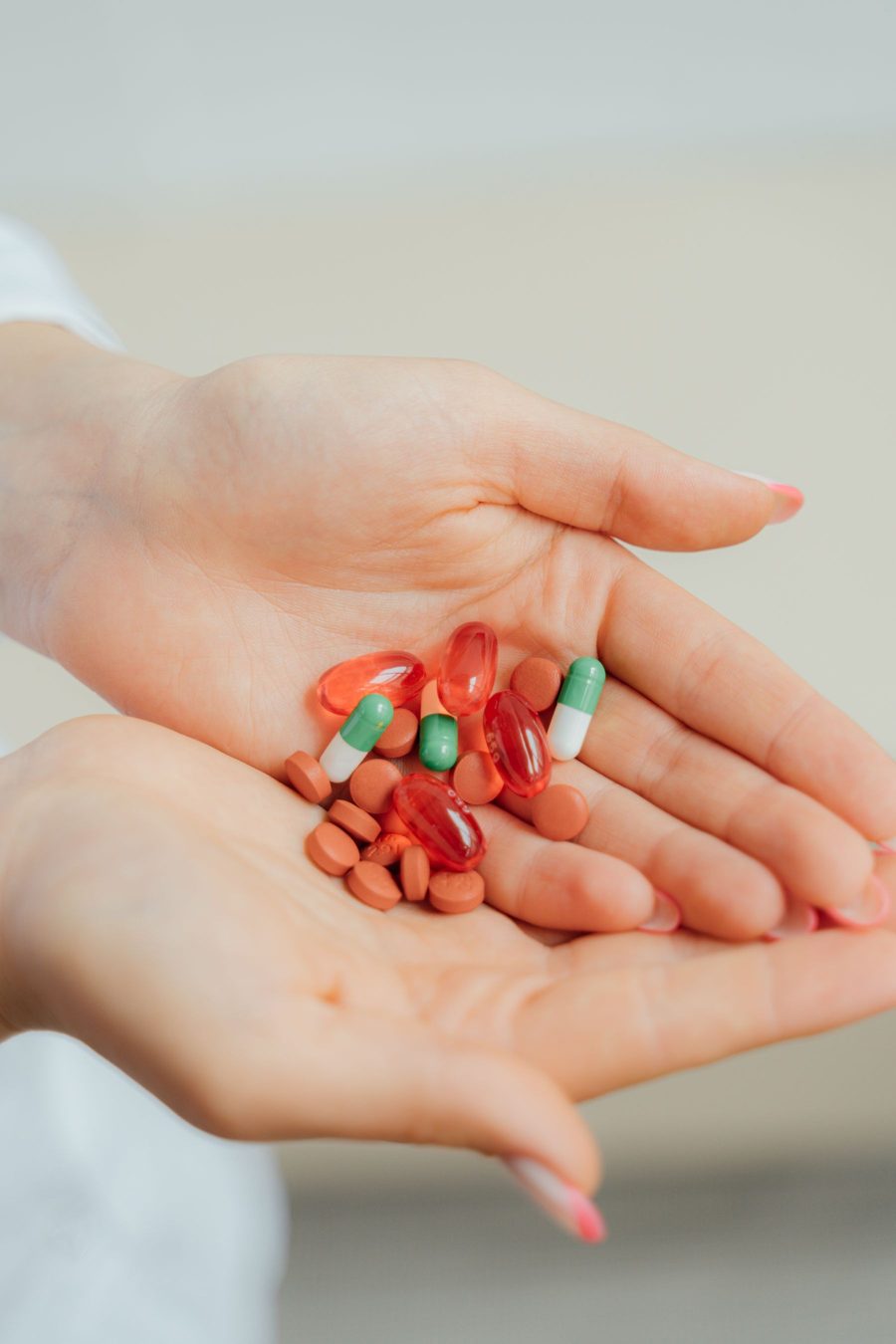 An open hand holding a day's worth of prescription tablets