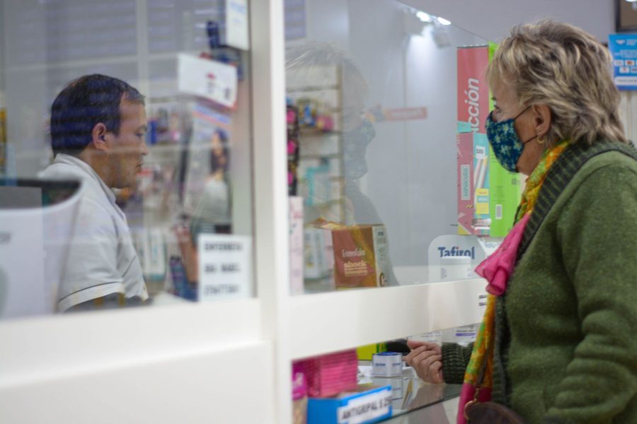 A customer picking up a prescription at the pharmacy pickup window