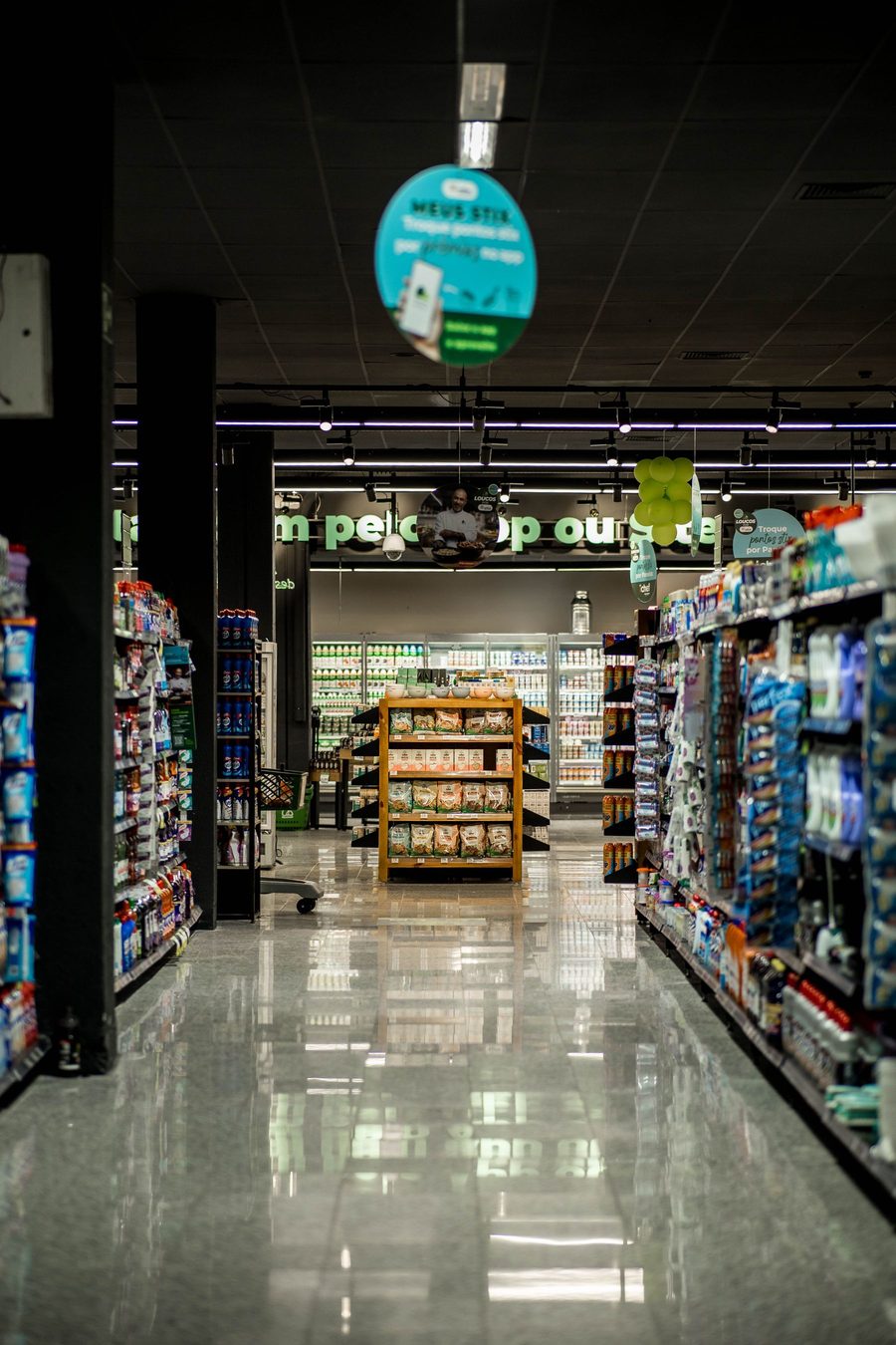 The bright interior aisle of a modern neighborhood pharmacy