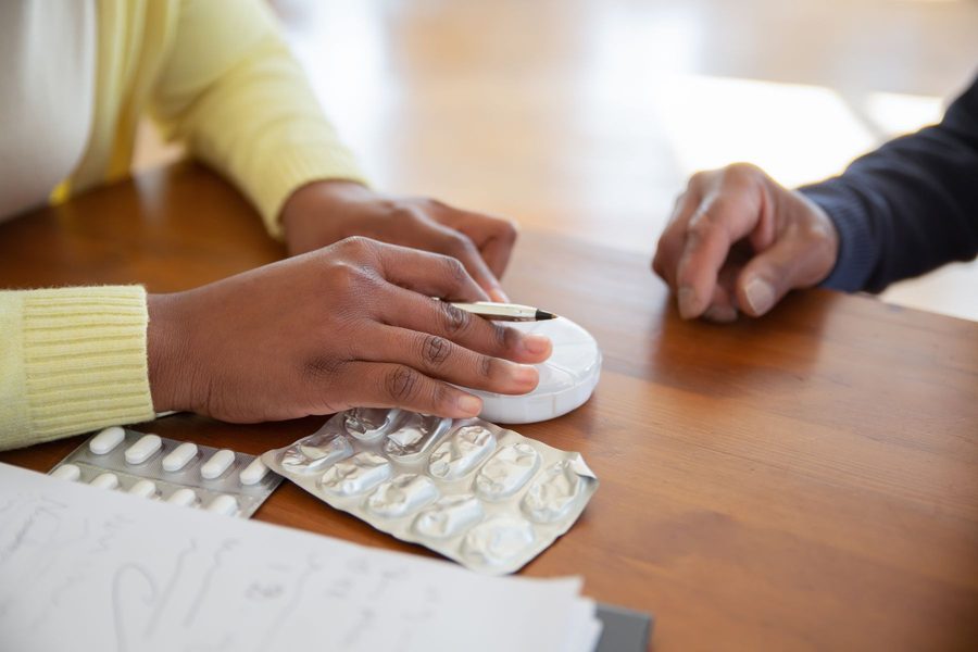 A pharmacist reviewing a medication list one-on-one with a patient